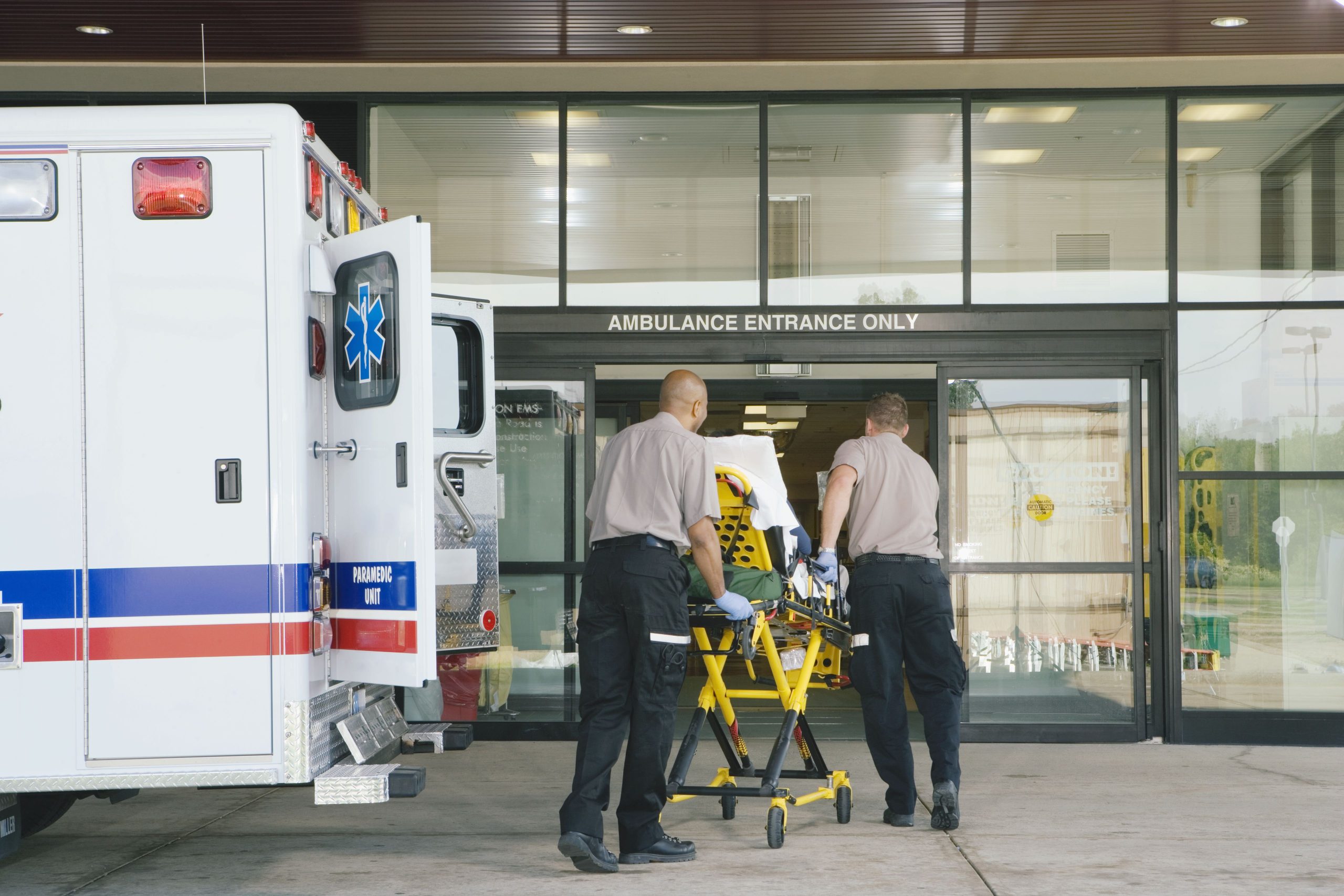 This image has an empty alt attribute; its file name is paramedics-taking-patient-on-stretcher-from-ambulance-to-hospital-73807258-5a88d8d46edd6500367cbb75-scaled.jpg